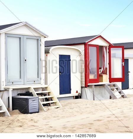 beach huts or houses and clear blue sky. Multicolored beach huts in in a row.
