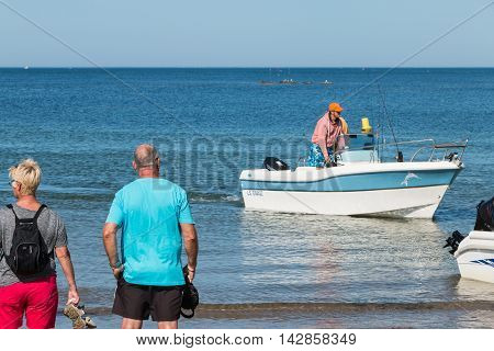 Men Returning From A Sea Fishing Competition