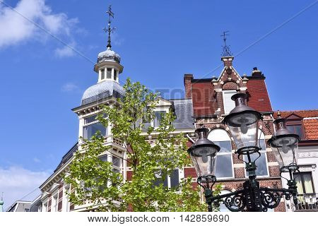 Lovely, historic house facade with turret and blue sky.