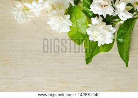 Jasmine Flowers Grouped On Wooden Board Background
