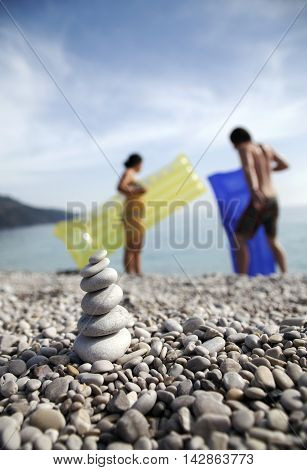 Stacked stones and people at the beach