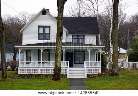 WEQUETONSING, MICHIGAN / UNITED STATES - DECEMBER 22, 2015: An elegant white Victorian home on Pennsylvania Avenue in Wequetonsing.