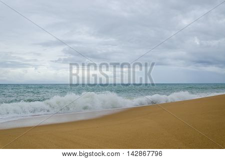Beach in cloudy day the sea and yellow sand