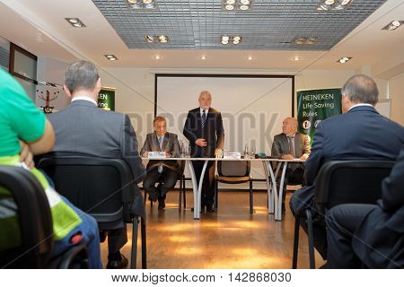ST. PETERSBURG, RUSSIA - AUGUST 11, 2016: Vice-governor of St. Petersburg Igor Divinsky talks with workers of the Heineken brewery. The brewery can produce over 5 millions HL of beer per year