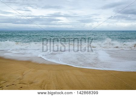 Beach in cloudy day the sea and yellow sand