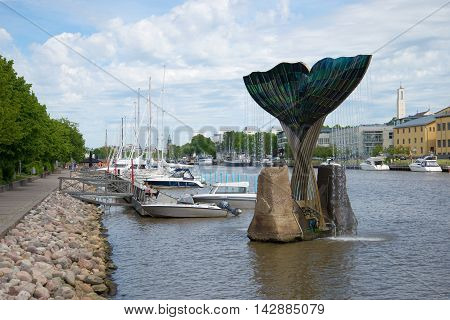 TURKU, FINLAND - JUNE 13, 2015: June day on the river Aura. The view of the fountain 