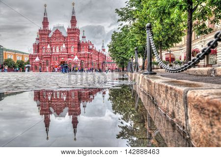 Moscow Russia - June 09 2016: Building of Historical museum reflecting in pudle on the Red Square