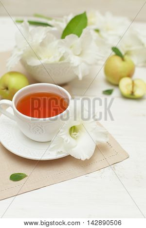 Summer tea with gladiole flowers sweet background
