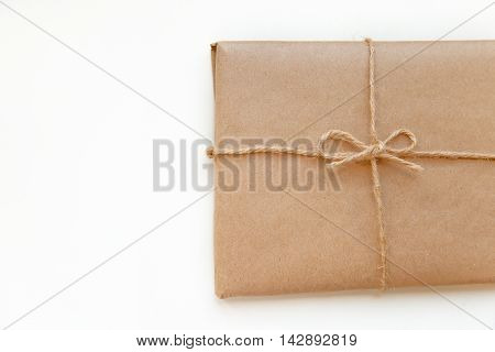 Vintage package tied up with string isolated on a white background