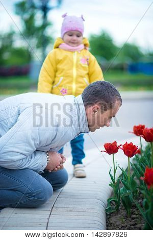 Little girl playing with her father in park
