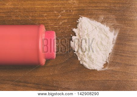Baby talcum powder container over a wooden table