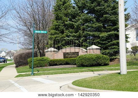 JOLIET, ILLINOIS / UNITED STATES - MAY 26, 2016: A sign marks the entrance to the Wesmere Highlands neighborhood of Joliet's Wesmere Country Club subdivision.