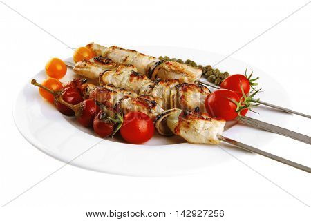 fresh turkey barbecue shish kebab served with tomatoes capers on platter isolated over white background