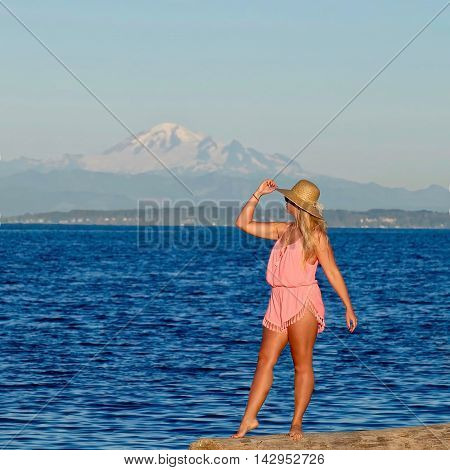 Young woman by ocean and mountain. Centennial Beach in Boundary Bay Regional Park Tsawwassen British Columbia Canada