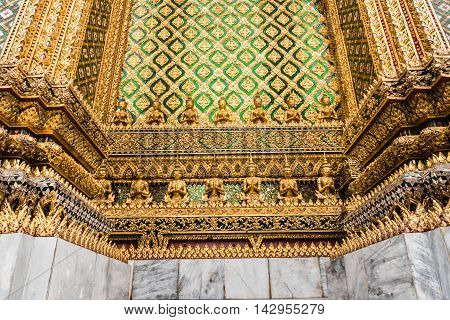BANGKOK THAILAND - MARCH 28 2016: Detail of carvings on temple wall at Wat Phra Kaew the most sacred Buddhist temple and the most famous tourist attraction in Bangkok Thailand.