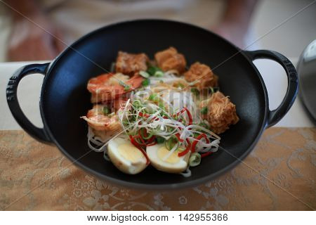 char-grilled tiger prawns with fried tufo and eggs.