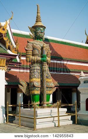 BANGKOK THAILAND - MARCH 9 2016: The green giant demon guarding an exit to Grand Palace at Wat Phra Kaew in Bangkok Thailand.