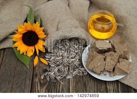 Sunflower, sunflower seeds, oil and sweets on stoly in a garden