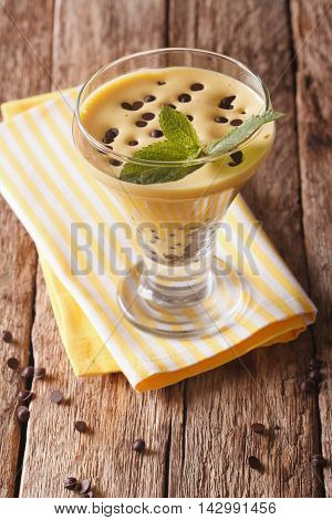 Italian Zabaione Dessert With Chocolate Close Up In A Glass. Vertical