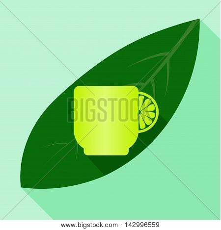 Yellow tea cup with lemon on green leaf