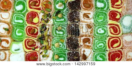 Different colorful tasty Turkish sweet as background