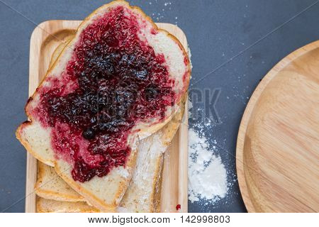 Bread And Blackcurrant Jam On Wood Plate