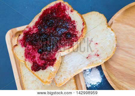 Bread And Blackcurrant Jam On Wood Plate