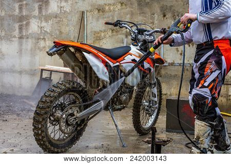 Biker A Man Cleaning Motorcycle From A High Pressure Washer