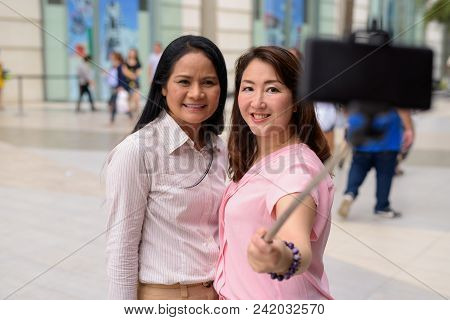 Portrait Of Two Mature Asian Women Together Outside The Mall In Bangkok City