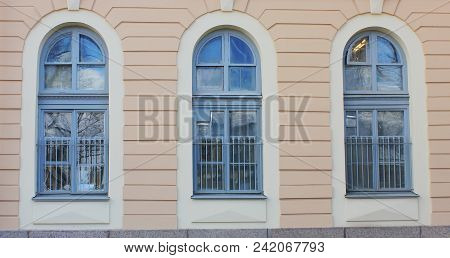 Three Arch Windows In Row On Building Wall Of Classic Stone House. Architecture Detail Of Historic P