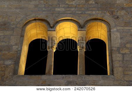 Ancient Window With Three Ogives Separated By Two Columns In The Ancient Palace At Night