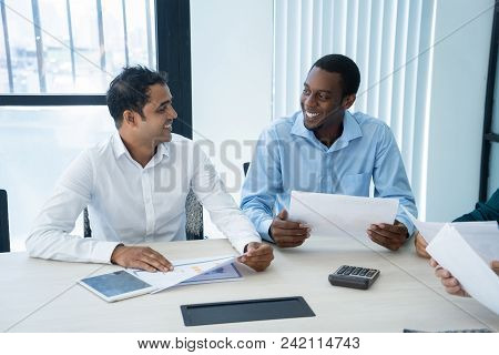 Two Positive Business Colleagues Having Friendly Small Talk During Meeting. Smiling Office Workers S