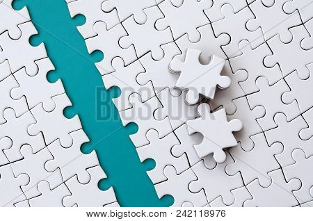 The Blue Path Is Laid On The Platform Of A White Folded Jigsaw Puzzle. The Missing Elements Of The P