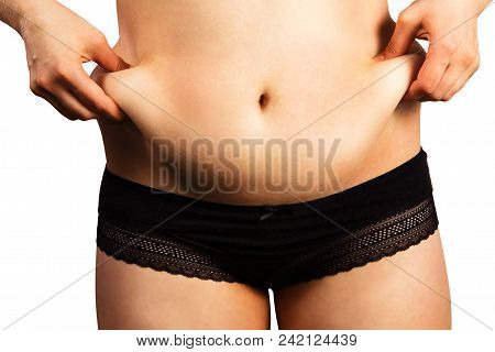 Body Of Young Woman With Excess Weight, Keeping Your Belly Fat, Isolated On White Background. Belly 