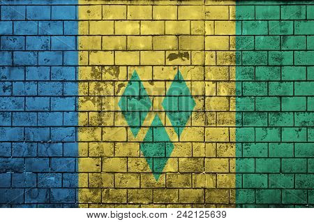 Saint Vincent And The Grenadines Flag Is Painted Onto An Old Brick Wall