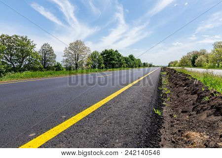 New Empty Road With Green Trees On Sides