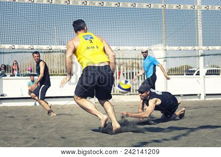 Ostia, Italy. May 12, 2015: Rushing Man Try To Receive The Ball During A Beach Volley Match Between 