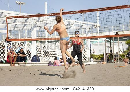 Ostia, Italy. May 12, 2015: Woman Hit The Ball Jumping During A Beachvolley Match Between Friends On