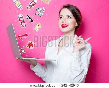 Portrait Of Young Redhead Businesswoman With Laptop On Pink Background