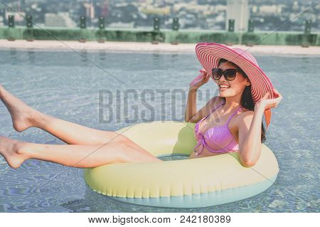 Swimsuit Concept. Beautiful Girl Wearing Pink Swimsuit. Beautiful Girl In Swimwear Is Relaxing At Th