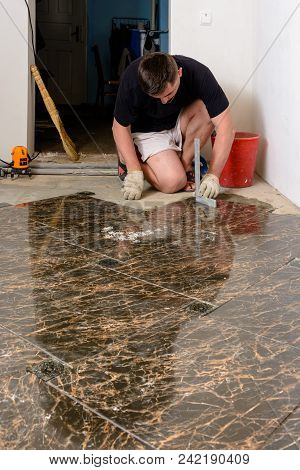 A Person With A Laser Level Checks The Installed Floor Tile 2018