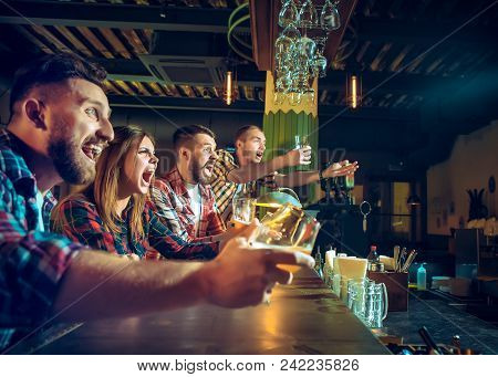 Sport, People, Leisure, Friendship, Entertainment Concept - Happy Male And Female Football Fans Or G
