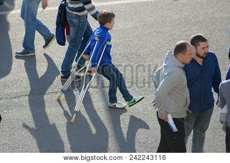 Minsk, Belarus - May 23, 2018: Little Fan On Crutches With A Leg Injury Before The Belarusian Premie