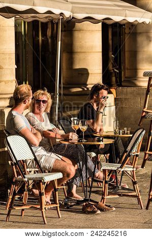 Paris, France - June 25, 2017: Parisians And Tourists Sit On The Terrace Of Le Nemours Cafe In The S
