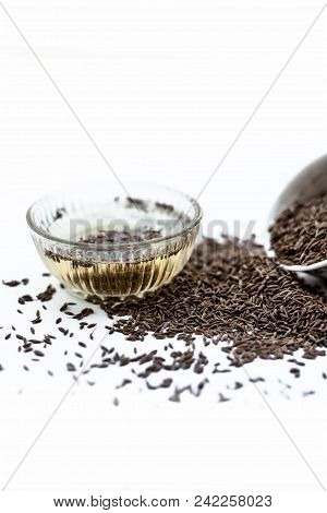 Common Cumin Or Zeera Or Jeera In A Bowl Isolated On White With Its Extracted Water In A Bowl.