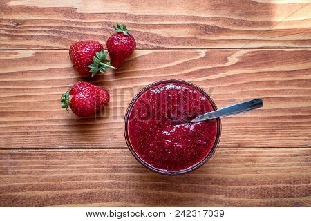 Homemade Strawberry Jam In A A Glass Bowl With Fresh Ripe Strawberries On A Wooden Table