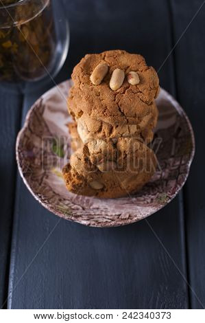 A Glass Of Tea On A Black Wooden Background And A Biscuit Biscuit. Copy Cpace,