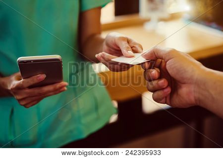 Closeup The Hand Of Businessman Is Holding Hand Credit Card And Hand Of Businesswoman Reading Text M