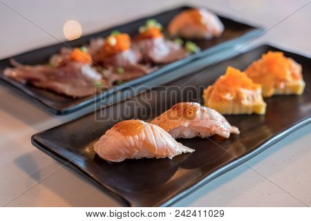 Set Of Grilled Wagyu Beef Sushi With Flying Fish Roe Or Tobiko And Salmon Aburi Sushi With Saikyo Sa