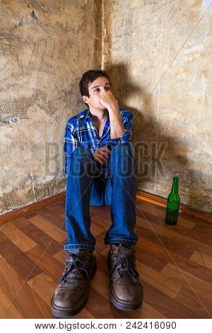 Pensive Young Man With A Beer By The Old Wall